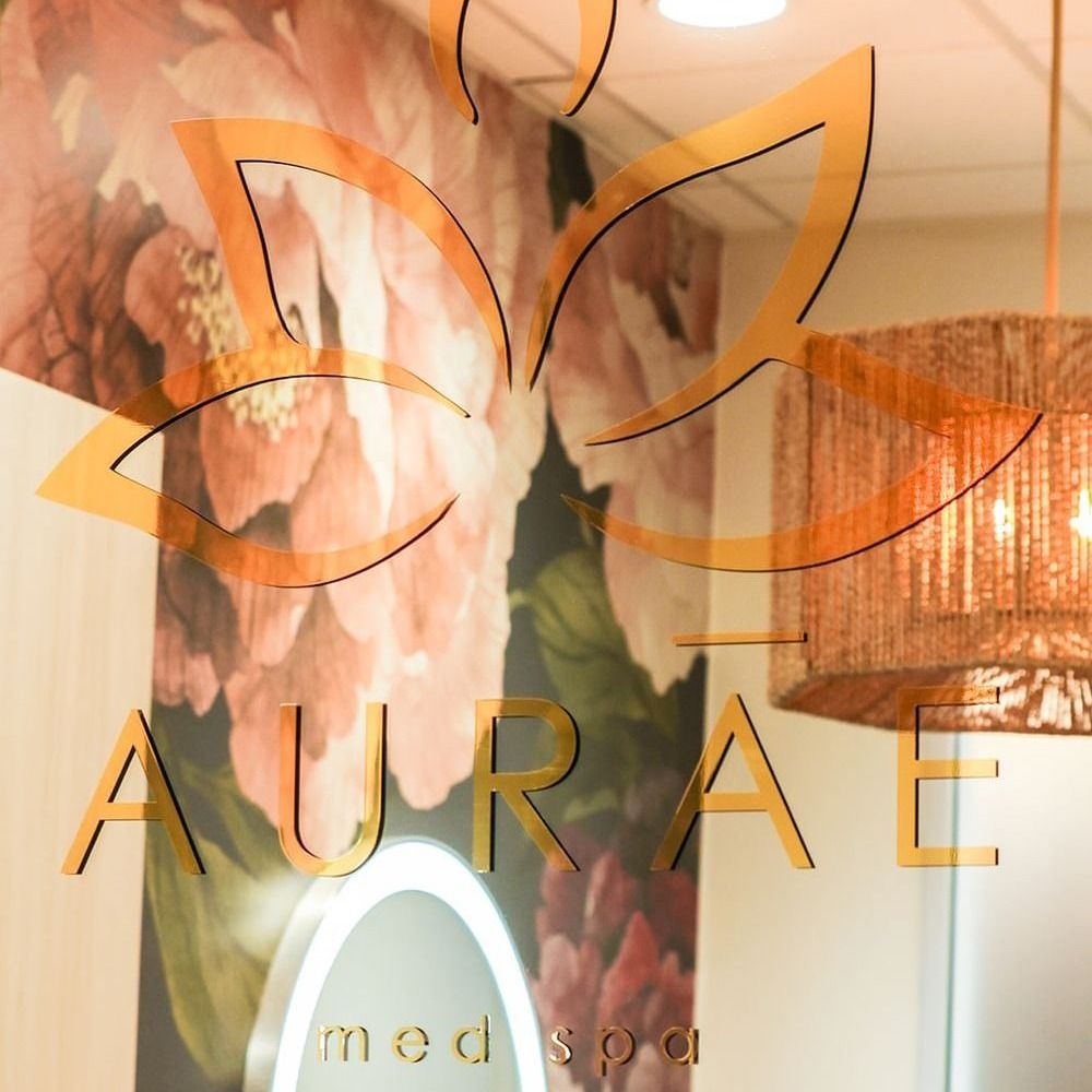 aurae med spa logo on glass